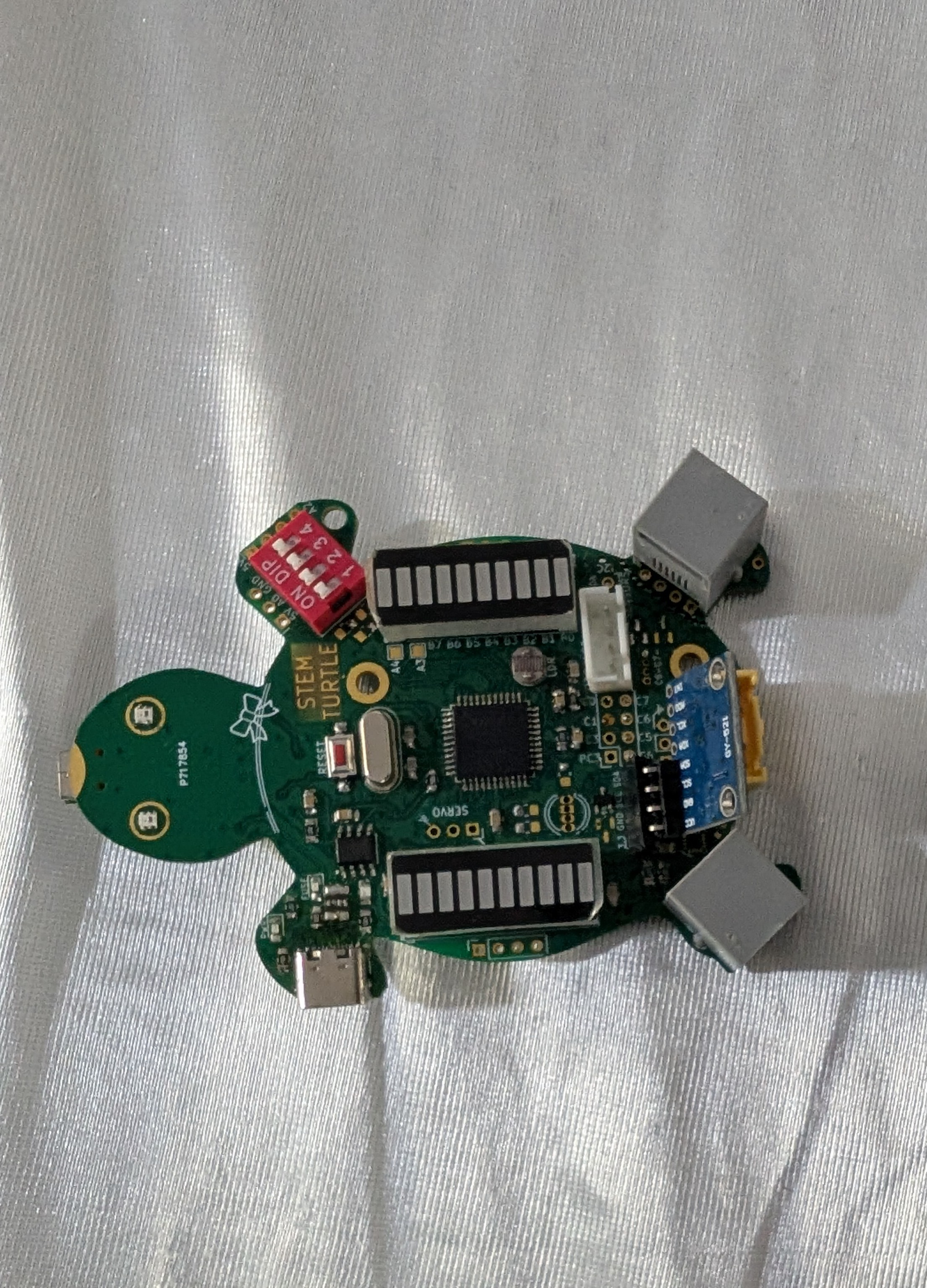 A green PCB with turtle shape which was designed using Inkscape, and then imported into KiCAD.